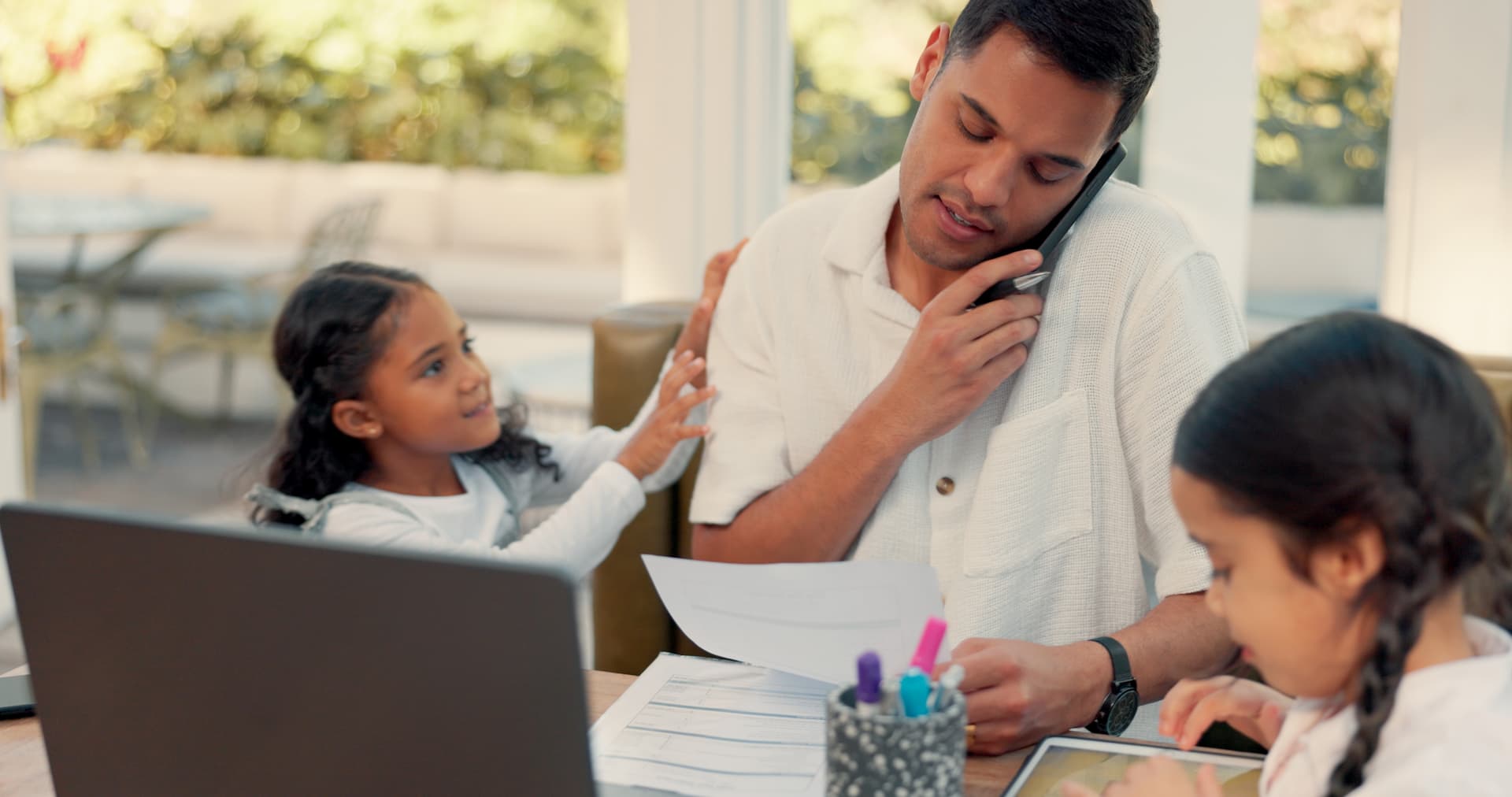 parent working with two kids nearby