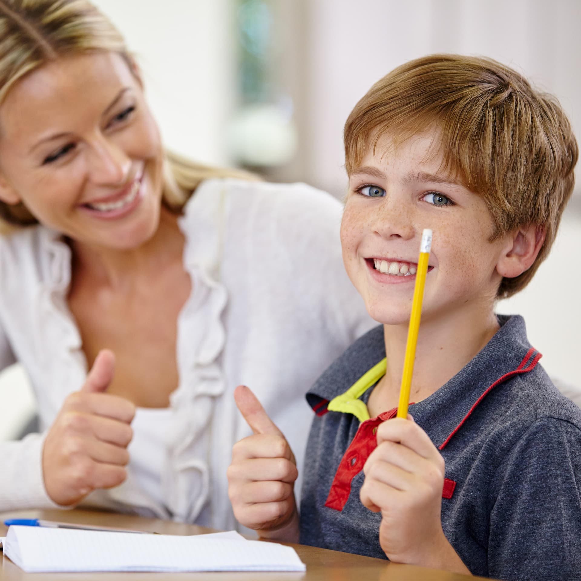 tutor with happy writing student